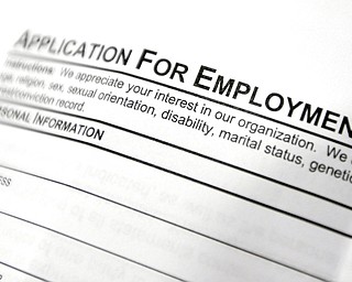 FILE - This April 22, 2014, file photo shows an employment application form on a table during a job fair at Columbia-Greene Community College in Hudson, N.Y. On Thursday, June 8, 2017, the Labor Department reports on the number of people who applied for unemployment benefits a week earlier. (AP Photo/Mike Groll, File)