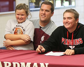 William D. Lewis The Vindicator Brian Terlesky with his dad Brian Terlesky Sr (also golf coach) and sister Emma, 7, during signing day at Boardman HS 11-8-17.