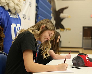 Adria Powell(left) and Claire Gagliardi sign their letters of intent for Ohio State University, Wednesday, Nov. 8, 2017, in the Hubbard High School Gymnasium in Hubbard. Gagliardi and Powell are both attending Ohio State University, playing gymnastics and volleyball respectively...(Nikos Frazier | The Vindicator)