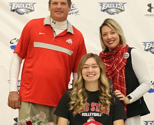 Adria Powell(center) poses for a photo with her parents, Greg(left) and Olivia Powell after signing her letter of intent to attend Ohio State University and play volleyball, Wednesday, Nov. 8, 2017, in the Hubbard High School Gymnasium in Hubbard...(Nikos Frazier | The Vindicator)