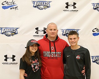 Claire Gagliardi(left) poses for photos with her father, Tony(center), and brother, Anthony, Wednesday, Nov. 8, 2017, in the Hubbard High School Gymnasium in Hubbard. Gagliardi plans on attending Ohio State University to play gymnastics...(Nikos Frazier | The Vindicator)