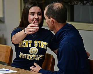 CORTLAND, OHIO - NOVEMBER 8, 2017: Annie Pavlansky gets a hug from her father Tom, after signing her letter of intent while sitting next to her parents Tom, right, and Kate, Wednesday morning at Lakeview High School. DAVID DERMER | THE VINDICATOR