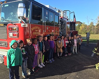 Various local professionals recently brought their vehicles to Brookfield Elementary School as part of Vehicle Day. The event was designed to expose students to a variety of career opportunities that require vehicles, such as postal workers, firefighters, construction workers, police officers and more. The vehicles were parked outside the school, and each classroom got to learn from the guests about their professions and why their vehicle is important. Guests included the Brookfield Police and Fire departments, Masury Branch of the U.S. Postal Service, A&W Lawn Care Service, Trumbull County Dog Warden and Sheriff’s department, GW Becker Inc. and a special visitor, country singer Chris Higbee. Above, the students in Mrs. Zebroski’s class learned from Brookfield firefighters about fire safety and the equipment they use on their trucks.