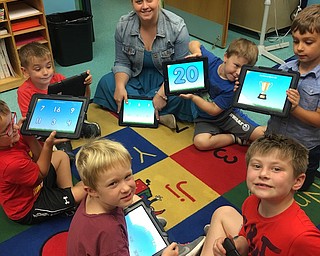 All preschool, transitional kindergarten and kindergarten classes at Ursuline Preschool and Kindergarten visit the technology room throughout the week. The 3- and 4-year-olds visit one day a week, and the transitional and regular kindergarten classes visit three to four days per week. Britney Wilkins, the technology teacher, and the students, use iPads, desktop computers and a smart board to enhance the learning experience. They practice math, language arts, social studies and science skills through applications, interactive presentations and more. Pictured aabove are Wilkins and the kindergarten boys using iPads to trace numbers 1 through 20. Below, Luca Schneider, transitional kindergartener, is learning letter sounds on abcya.com.
