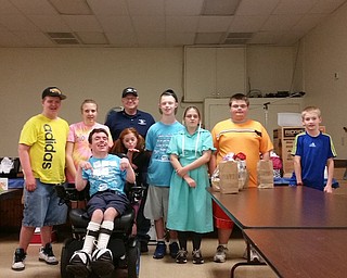 The Summer Enrichment Program for Handicapped Children of Trumbull County recently hosted its annual basket raffle and bake sale at Candlelite Knolls in Warren. The event has taken place for more than 20 years. Thanks to the generosity of the Bazetta-Cortland Optimist Club, a donation of $675 was made to the program from the proceeds of the concession stand. Above, in front, is Rocky Maiorca. Second row, from left, are Tyler Littel, Brianna Womer, Adia Bury, Gage Tichenor, Rebecca Hostetler, Everett Westover and Logan Bingham. In back is Mike Popadak, Optimist president.