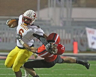   ROBERT K YOSAY  | THE VINDICATOR..CM #6  Andre McCoy  stiff arms SBR Javon Davis as he comes out of the back field during first half action at Cardinal Mooney vs Steubenville Big Red at Salem Stadium...-30-