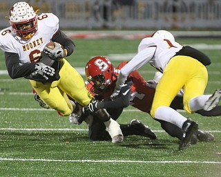   ROBERT K YOSAY  | THE VINDICATOR..CM# #6 breaks a tackle from SBR  #14Randy Mitchell as  CM#12 John Murphy - during first half action..Cardinal Mooney vs Steubenville Big Red at Salem Stadium...-30-