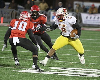   ROBERT K YOSAY  | THE VINDICATOR..CM #6 Andre McCoy picks his way thru a whole as SBR #10 Alec Taylor ( i think)  and SBR#24 Jeziah Blackwell - Cardinal Mooney vs Steubenville Big Red at Salem Stadium...-30-