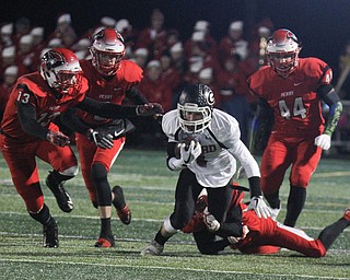 he Vindicator  Girard's Aidan Warga(4) ) eludes a host of Perry defenders during 1rst half action at Twinsburg.