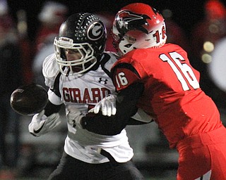 The Vindicator William D Lewis .Girard's Aiden Warga(4) tries to keep control of the ball while being tackled Perry's Jacob Allen(16) during 1rst half action at Twinsburg.