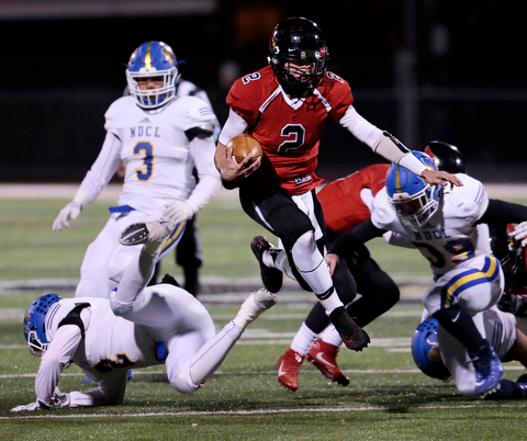 WARREN, OHIO - NOVEMBER 10, 2017:  Canfield's Vinny Fiorenza (2) leaps over NDCL Matt Tuohey (2) as he gains a 1st down  during the 1st qtr. at Harding High School, Mollenkopf Stadium.  MICHAEL G TAYLOR | THE VINDICATOR