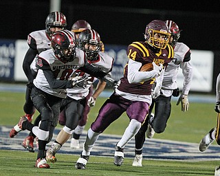 Aniello Buzzacco (14) finds a hole in the Manchester defense during the first half of Friday nights matchup at Louisville High School in Louisville.  Dustin Livesay  |  The Vindicator  11/10/17  Louisville.