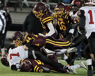 Ethan Wright (7) of Manchester gets driven backward by a group of South Range defenders during the first half of Friday nights matchup at Louisville High School in Louisville.  Dustin Livesay  |  The Vindicator  11/10/17  Louisville.