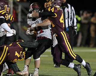 Peyton Remish (44) of South Range wraps up Hunter Foster (34) of Manchester during the first half of Friday nights matchup at Louisville High School in Louisville.  Dustin Livesay  |  The Vindicator  11/10/17  Louisville.