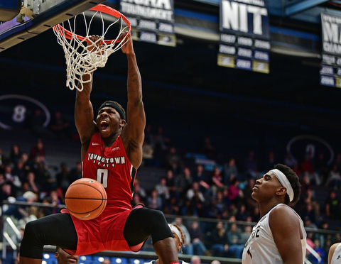 AKRON, OHIO - NOVEMBER 11, 2017: Youngstown State's Tyree Robinson, left, dunks over Kent State's Adonis De La Rosa during the first half of their game Saturday night at James A. Rhodes Arena. DAVID DERMER | THE VINDICATOR
