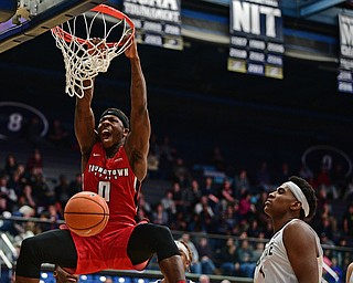AKRON, OHIO - NOVEMBER 11, 2017: Youngstown State's Tyree Robinson, left, dunks over Kent State's Adonis De La Rosa during the first half of their game Saturday night at James A. Rhodes Arena. DAVID DERMER | THE VINDICATOR