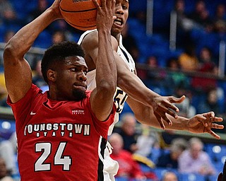 AKRON, OHIO - NOVEMBER 11, 2017: Youngstown State's Cameron Morse grabs a rebound away from Kent State's Kevin Zabo during the first half of their game Saturday night at James A. Rhodes Arena. DAVID DERMER | THE VINDICATOR