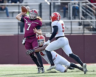 Southern Illinois quarterback Matt DeSomer (7) is pressured by Youngstown State defensive lineman Donald Mesier (9) and linebacker Lee Wright (5) as he passes in the second quarter at Saluki Stadium on Saturday.