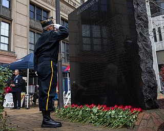 Rebecca Devereaux | The Vindicator ..Honor Guard Army veteran Tony Viano of Lake Milton salutes the Mahoning County Vietnam Memorial with the names of the 100 soldiers who were killed in action while serving in the war.