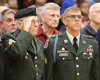 ROBERT K YOSAY | THE VINDICATOR..honored vets at Boardman Glenwood Jr High salute the entry of the flags by students...Paul Eicher and Keith Colovos both served in the Army..at Boardman although veterans day isn't till tomorrow. area schools honored vets with songs or breakfast and shows......-30-