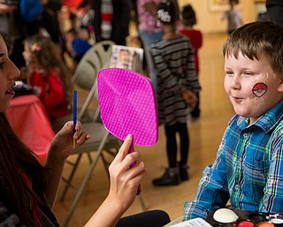 Six-year-old Torrent Westfall reacts to his new face paint during the Butler Institute of American Art Family Fun Day on Sunday at the museum in Youngstown.