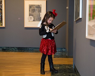 Chloe Morgan, 5 of Niles writes down her findings during a scavenger hunt activity during the Butler Institute of American Art Museum Family Fun Day on Sunday in Youngstown.