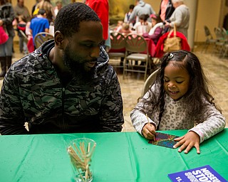 Five-year-old Ava Wise of Camel works on her scratch art, next to her dad, Justin at the Butler Institute of American Art museum Family Fun Day on Sunday in Youngstown.