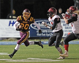 Josh Stear (20) of South Range tries to get to the corner around the tackle by Manchester's Coye Schuler during the first half of Friday nights matchup at Louisville High School in Louisville. Dustin Livesay | The Vindicator 11/10/17 Louisville.