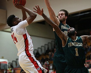 Youngstown State guard Cameron Morse (24) puts up two as Franciscan guard Kevin Jarmusik (24) and Franciscan forward Juwan Perkins (1) try to block his shot during the first half of a NCAA College Basketball game, Tuesday, Nov. 14, 2017, at Beeghly Center in Youngstown. Youngstown State won 134-46...(Nikos Frazier | The Vindicator)..