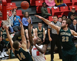 Youngstown State forward Tyree Robinson (0) goes up for two against Franciscan center Matt Trent (14) and Franciscan center JP Dombrowski (23) during the first half of a NCAA College Basketball game, Tuesday, Nov. 14, 2017, at Beeghly Center in Youngstown. Youngstown State won 134-46...(Nikos Frazier | The Vindicator)..