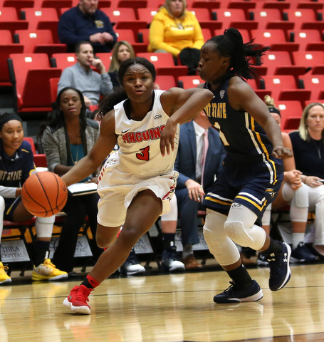 Youngstown State guard Indiya Benjamin (3) charges to the net against Kent State guard Naddiyah Cross (1) during the first quarter of a NCAA College Basketball game, Tuesday, Nov. 14, 2017, at Beeghly Center in Youngstown. Kent State won 55-44...(Nikos Frazier | The Vindicator)..