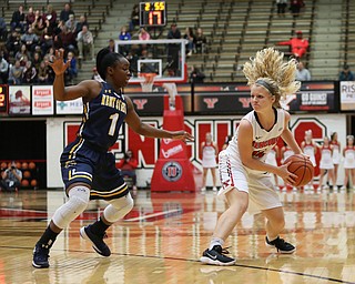 Youngstown State guard Melinda Trimmer (14) spins away from Kent State guard Naddiyah Cross (1) during the first quarter of a NCAA College Basketball game, Tuesday, Nov. 14, 2017, at Beeghly Center in Youngstown. Kent State won 55-44...(Nikos Frazier | The Vindicator)..