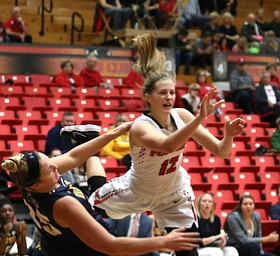 Youngstown State guard Chelsea Olson (12) falls down after colliding with Kent State guard Monique Smith (25) during the second quarter of a NCAA College Basketball game, Tuesday, Nov. 14, 2017, at Beeghly Center in Youngstown. Kent State won 55-44...(Nikos Frazier | The Vindicator)..
