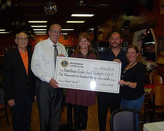 The Boardman Lions Club met recently at Los Gallos Restaurant and donated $1,139.50 from its fundraiser, “Dinner in the Dark,” to Boardman Center Intermediate School food pantry. Above, from left, are Mike Iberis, Second Harvest Food Bank; Randy Ebie, principal of BCIS; Mindy DePietro, guidance counselor; Matt Gambrel, Lions president; and Laura Sobotka, Lions member.

