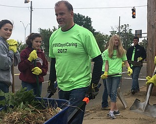 Neighbors | Submitted.Director of Operations Jack Zocolo lifted a wheelbarrow of weeds and other growth on Sept. 1 with the United Way and Boardman's Emerging Leaders group. The group's advisor is English teacher Dana Safarek.