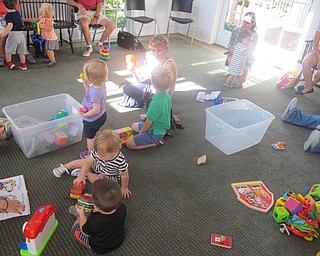 Neighbors | Zack Shively.The children played with toys at the end of Bonding with Babies and Books after sining and reading along with libarian Vicki Peck.