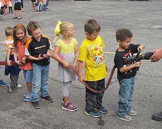 Neighbors | Zack Shively.Boardman Stadum Elementary kindergarten students took turns holding the fire hose and nozzle.