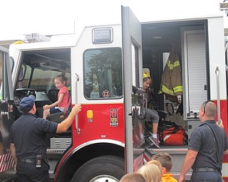 Neighbors | Zack Shively.Boardman firefighters Shawn Conroy (left) and Jon Park (right) helped the kindergarten students into the fire truck.