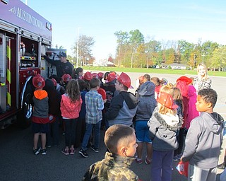 Neighbors | Zack Shively.Firefighter Chase Kovacs showed the different equipment on the fire truck to second-grade students at Austintown Elementary School on Oct. 19 during a fire safety assembly created by the AES PTA.