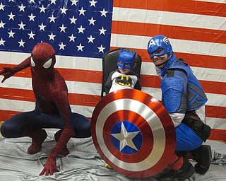 Neighbors | Zack Shively.Boardman Park invited heroes from Spectacular Party Entertainment to pose for pictures throughout the Mom and Son Knight. Pictured is Harrison Roman between two heroes.