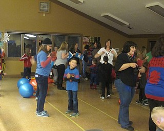 Neighbors | Zack Shively.Karen McCallum, Recreation Director at Boardman Park, organized the Mom and Son Knight. She told the parents when to switch between the stations. She would play a song between the switch. Pictured, McCallum played the chicken dance and the moms danced with their sons.