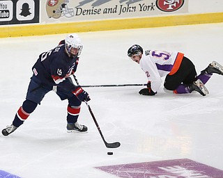 Team USA forward John Beecher (52) skates away with the puck as Youngstown Phantoms center Craig Needham (52)  slides away during the second period as Team USA takes on the Youngstown Phantoms, Friday, Nov. 17, 2017, at the Covelli Centre in Youngstown...(Nikos Frazier | The Vindicator)..