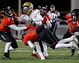 SALEM, OHIO - NOVEMBER 17, 2017:  Canfield's Nick Ieraci (9), Dominick Gelonese (3), Paul Breinz (4) and David Crawford (23) gang tackle SVSM Scott Walter (5) stopping him for a loss during the 1st qtr. at Reilly Stadium, Salem High School.  MICHAEL G TAYLOR | THE VINDICATOR
