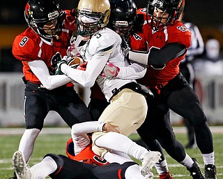 SALEM, OHIO - NOVEMBER 17, 2017:  Canfield's Nick Ieraci (9), Dominick Gelonese (3), Paul Breinz (4) and David Crawford (23) gang tackle SVSM Scott Walter (5) stopping him for a loss during the 1st qtr. at Reilly Stadium, Salem High School.  MICHAEL G TAYLOR | THE VINDICATOR