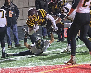 Aniello Buzzacco (14) leaps for extra yards over Black River's Garrett Hord (4) during the third quarter of Friday nights matchup in Canal Fulton .  Dustin Livesay  |  The Vindicator  11/17/17  Canal Fulton