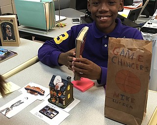Above, sixth-grade students in English Language Arts classes at Struthers Middle School recently presented “Book in a Bag” gallery walk. Each student chose a book to present, drafted a plot summary, collected artifacts and decorated a brown paper bag to explain the book. Classes took turns learning about one another’s books. below is Kanan Hickman, who presented “Game Changers” by Mike Lupica. At bottom, Marisa Orbin  shows her presentation on “The Ghost of Crutchfield Hall” by Mary Downing Hahn. Class teachers are Erica Loew and Jennifer Pint.
