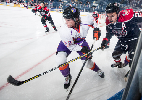 Scott R. Galvin | The Vindicator.Youngstown Phantoms center Curtis Hall (20) digs for the puck along the board as Chicago Steel defenseman Matteo Pietroniro (22) pursues him during the first period at the Covelli Centre on Saturday, November 18, 2017.