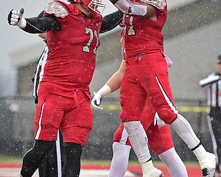 YOUNGSTOWN, OHIO - NOVEMBER 18, 2017: Youngstown State's Tevin McCaster, right, celebrates with Cameron Fraser after scoring a touchdown during the first half of Saturday afternoons game at Stambaugh Stadium. Youngstown State won 38-10. DAVID DERMER | THE VINDICATOR