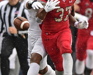 YOUNGSTOWN, OHIO - NOVEMBER 18, 2017: Youngstown State's Tevin McCaster fumbles the football after being hit by Missouri State's Angelo Garbutt during the first half of Saturday afternoons game at Stambaugh Stadium. Youngstown State won 38-10. DAVID DERMER | THE VINDICATOR