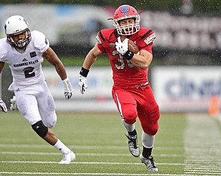 YOUNGSTOWN, OHIO - NOVEMBER 18, 2017: Youngstown State's Joe Alessi runs down the sideline away from Missouri State's Darius Joseph and into the end zone to score a touchdown during the first half of Saturday afternoons game at Stambaugh Stadium. Youngstown State won 38-10. DAVID DERMER | THE VINDICATOR